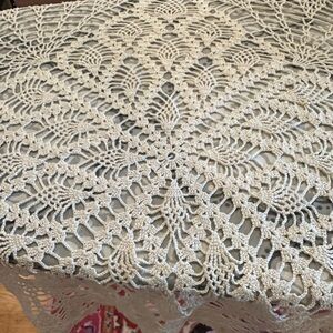 Cream colored open weave crocheted table topper. Vintage